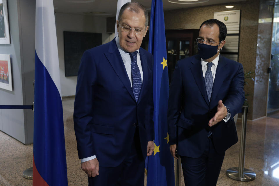 Russian Foreign Minister Sergey Lavrov, left, is greeted by his Cypriot counterpart Nikos Christodoulides as he arrives at the foreign ministry house for a meeting in the capital Nicosia, Cyprus, Tuesday, Sept. 8, 2020. Lavrov is paying an official visit to Cyprus amid heightened tensions over Turkey's search for energy resources in east Mediterranean waters where Greece and Cyprus claim as having exclusive economic rights. (AP Photo/Petros Karadjias)