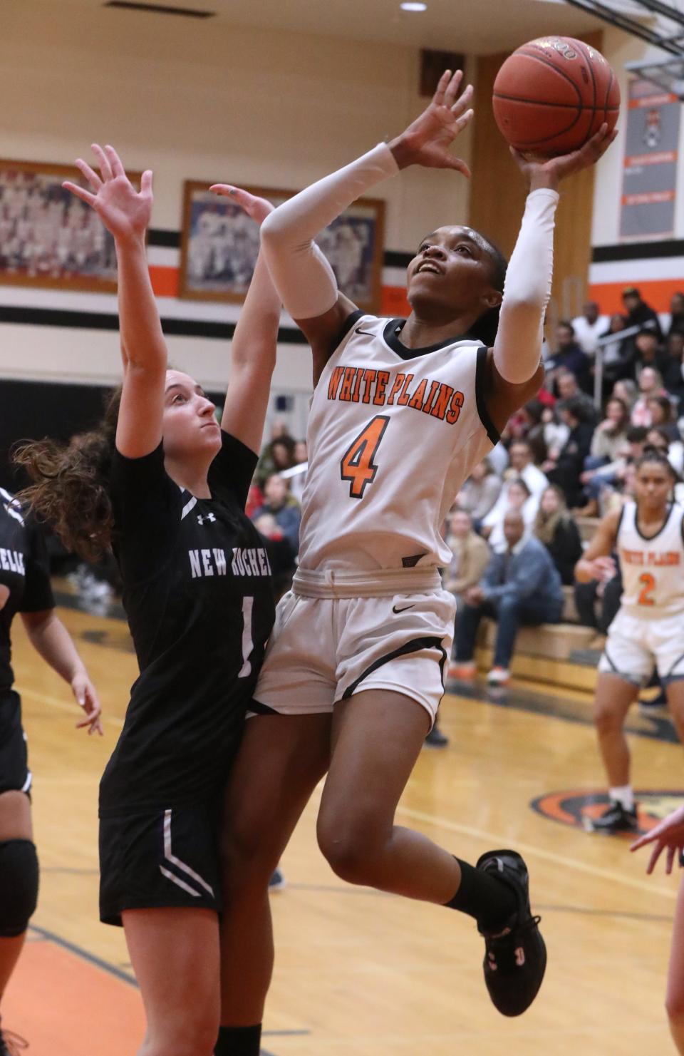 White Plains' Sequoia Layne shoots over New Rochelle's Olivia Fosina during a Section 1 Class AA quarterfinal at Mamaroneck Feb. 24, 2023. White Plains won 65-42.