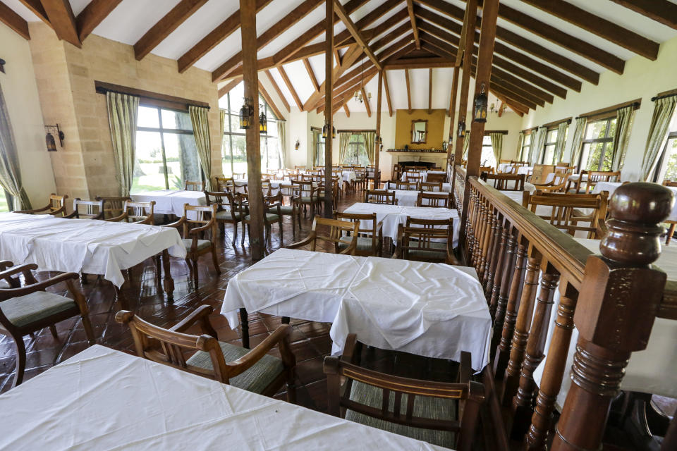 In this photo taken Friday, May 1, 2020, a dining room sits empty and devoid of tourists at the Ol Pejeta conservancy, in Kenya. Wildlife tourism is a major source of revenue for countries like Kenya and with African wildlife parks hit hard by the disappearance of tourists due to travel restrictions and the new coronavirus, some operators are now sharing broadcasts of safaris on social media in the hope that attention to endangered and other species doesn't fade. (AP Photo/Khalil Senosi)