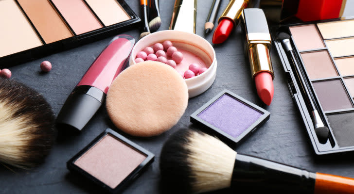 a collection of various cosmetic products on a black table