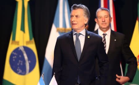 Argentina's President Mauricio Macri arrives for a working session alongside Argentine senator Julio Cobos at the Mercosur trade bloc summit in Mendoza, Argentina July 21, 2017. REUTERS/Marcos Brindicci