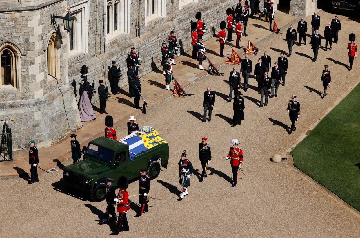 Members of the Royal family, led by Prince Charles, center left, and Princess Anne, center right, follow behind the coffin of Britain's Prince Philip in the Quadrangle at Windsor Castle in Windsor, England, Saturday, April 17, 2021.