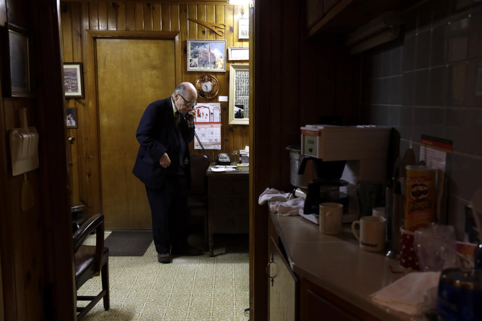 In this Tuesday, Oct. 30, 2012 photo, Dr. Russell Dohner makes a phone call in his office in Rushville, Ill. Even when the medical profession changed around him, he was always on call, ready to drop everything for a patient who might need him. (AP Photo/Jeff Roberson)