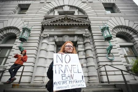 Beth Kohn protests outside the 9th U.S. Circuit Court of Appeals courthouse in San Francisco, California February 7, 2017, while the Court hears arguments regarding President Donald Trump's temporary travel ban on people from seven Muslim-majority countries. REUTERS/Noah Berger