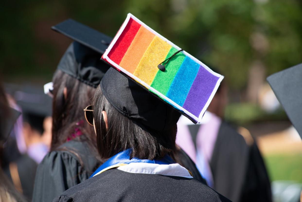 <span class="caption">Around 100,000 LGBTQ students study at religious institutions in the US.</span> <span class="attribution"><a class="link " href="https://www.gettyimages.com/detail/photo/woman-wears-graduation-cap-and-gown-showing-gay-royalty-free-image/1158696624?adppopup=true" rel="nofollow noopener" target="_blank" data-ylk="slk:iStock/Getty Images;elm:context_link;itc:0;sec:content-canvas">iStock/Getty Images</a></span>