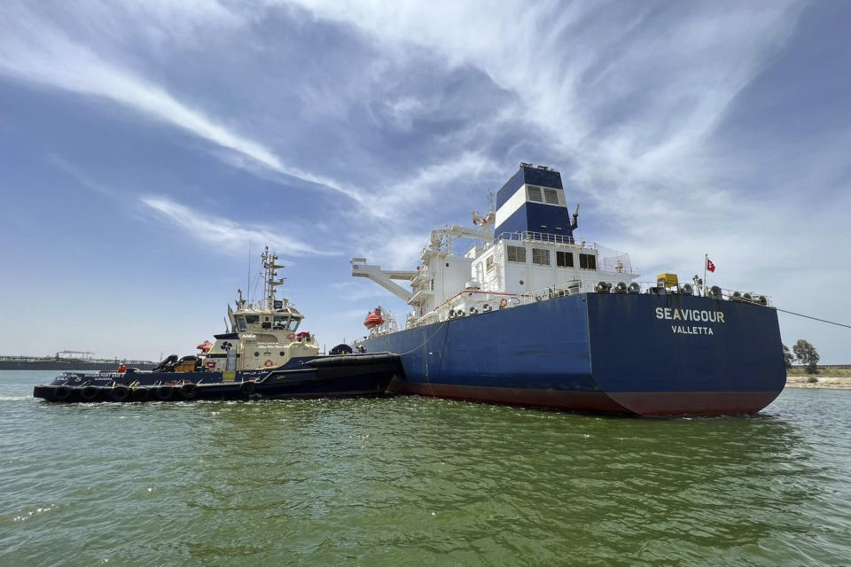 In this photo provided by Egypt's Suez Canal Authority, a tugboat pushes the Malta-flagged Seavigour after it suffered a mechanical malfunction at the 12 kilometers (7.5 miles) mark of the canal, Egypt, Sunday, June 4, 2023. Seavigour, which transporting crude oil, broke down in a single-lane part of Egypt's Suez Canal, briefly disrupting traffic in the global waterway, Egyptian authorities said. (Suez Canal Authority via AP)