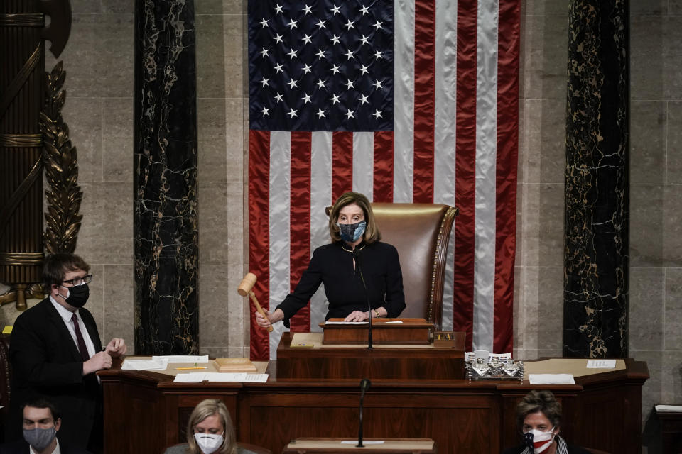 Speaker of the House Nancy Pelosi, D-Calif., leads the final vote of the impeachment of President Donald Trump, for his role in inciting an angry mob to storm the Congress last week, at the Capitol in Washington, Wednesday, Jan. 13, 2021. (AP Photo/J. Scott Applewhite)