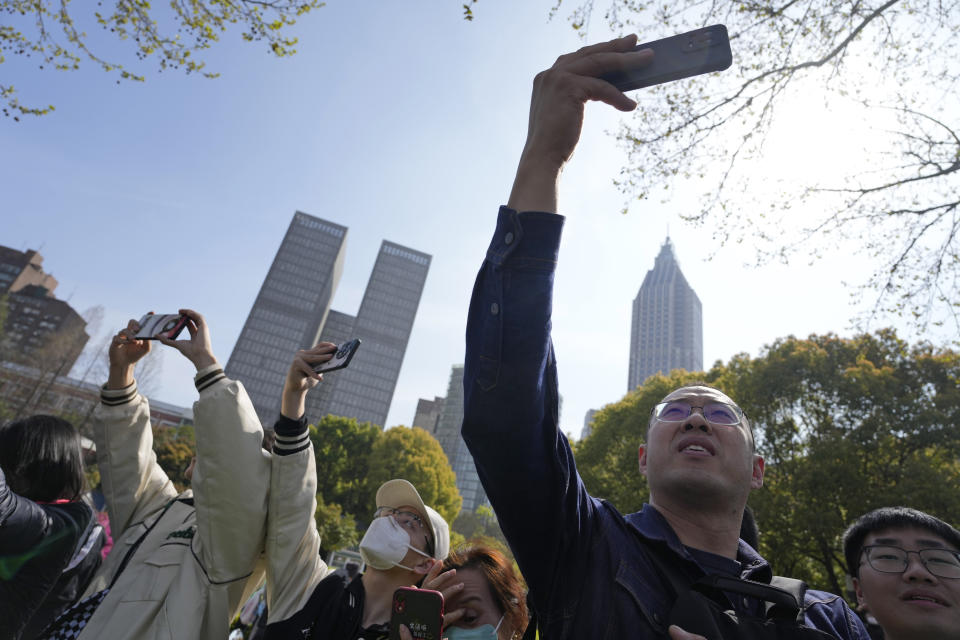 Residents try to catch a glimpse of former Taiwan President Ma Ying-jeou during his visit in Nanjing, in eastern China's Jiangsu province, Tuesday, March 28, 2023. Former Taiwan President Ma Ying-jeou began a 12-day tour of China with a symbolism-laden visit to the mausoleum where the founding father of both China and Taiwan is entombed. (AP Photo/Ng Han Guan)