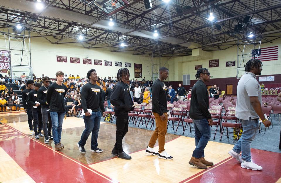 Southern Miss football players process in during a funeral service for teammate M.J. Daniels at George County High School in Lucedale, Miss., Saturday, June 22, 2024. Daniels, 21, a Southern Miss football player, was shot on June 11.