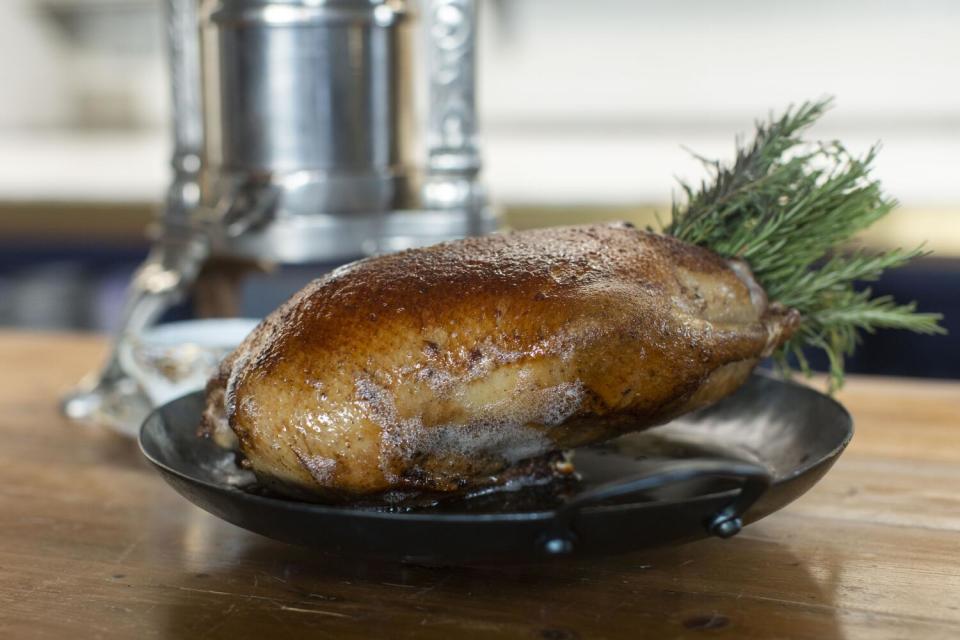 Pasjoli chef Dave Beran's Canard à la Rouennais à la Presse, served with a "tail" of rosemary stems