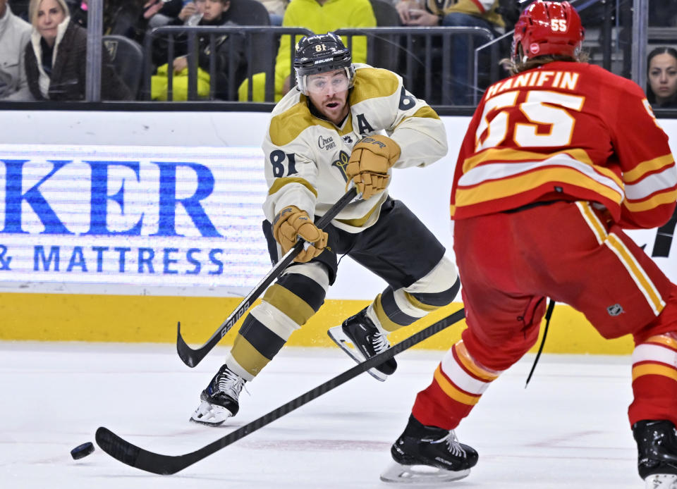 Vegas Golden Knights right wing Jonathan Marchessault (81) shoots against Calgary Flames defenseman Noah Hanifin (55) during the second period of an NHL hockey game Saturday, Jan. 13, 2024, in Las Vegas. (AP Photo/David Becker)