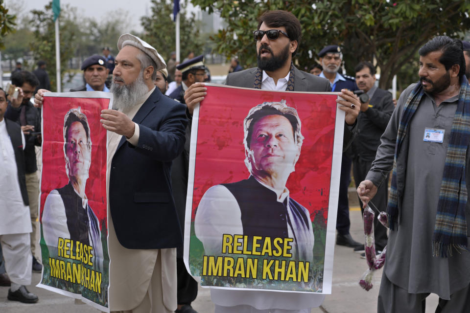 Pakistan's newly elected lawmakers displays a poster of their leader and imprisoned former Prime Minister Imran Khan as they arrive to attend opening session of the Parliament, in Islamabad, Pakistan, Thursday, Feb. 29, 2024. Pakistan's National Assembly swore in newly elected members on Thursday in a chaotic scene, as allies of jailed former Premier Khan protested what they claim was a rigged election. (AP Photo/Anjum Naveed)