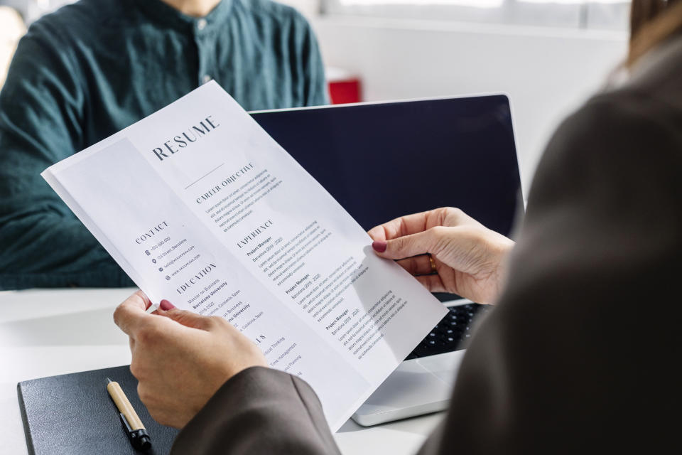 woman looking at an applicant's resume