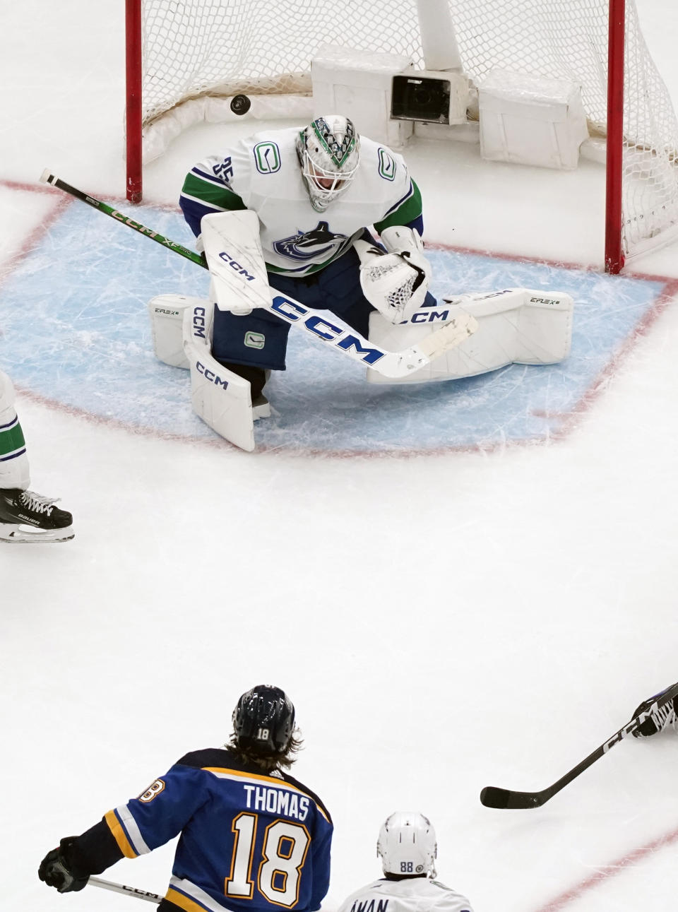 St. Louis Blues' Robert Thomas (18) scores past Vancouver Canucks goaltender Thatcher Demko during the third period of an NHL hockey game Thursday, Jan. 4, 2024, in St. Louis. (AP Photo/Jeff Roberson)