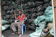 In this photo of Tuesday Oct. 30, 2012 a Somali charcoal trader listen to his radio as he waits for customers at his charcoal store in Mogadishu, Somalia. Thousands of sacks of dark charcoal sit atop one another in Somalia's southern port city of Kismayo, an industry once worth some $25 million dollar a year to the al-Qaida-linked insurgents who controlled the region. The good news sitting in the idle pile of sacks is that al-Shabab militants can no longer fund their insurgency through the illegal export of the charcoal. Kenyan troops late last month invaded Kismayo and forced out the insurgents, putting a halt to the export of charcoal, a trade the U.N. banned earlier this year in an effort to cut militant profits. The loss of the charcoal trade "will cut a major source of revenue and thus will have a detrimental effect on their operational capacity to carry out large scale attacks," Mohamed Sheikh Abdi, a Somali political analyst, said of al-Shabab. But the flip side to the charcoal problem is that residents who made their living from the trade no longer are making money, a potentially tricky issue for the Kenyan troops who now control the region. (AP Photo/Farah Abdi Warsameh)