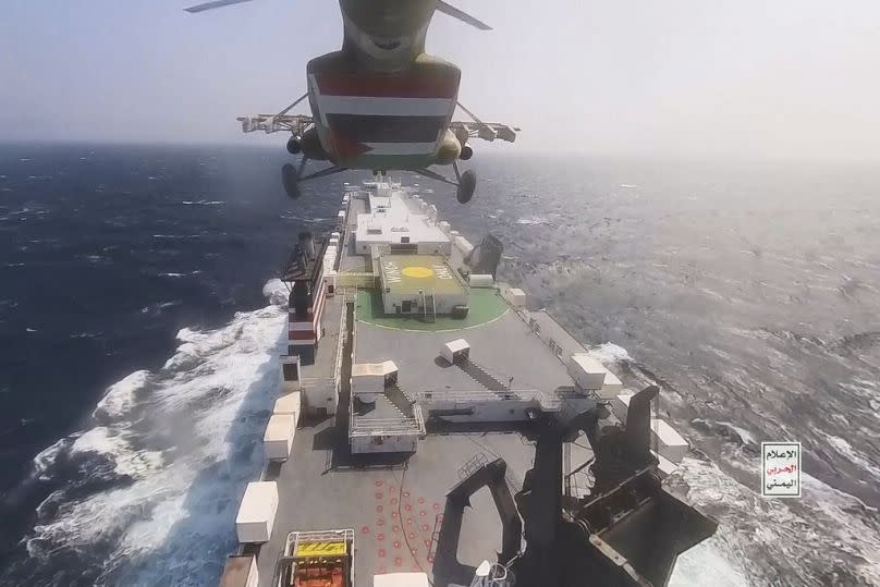 This photo released by the Houthi Media Center shows a Houthi forces helicopter approaching the cargo ship Galaxy Leader in November