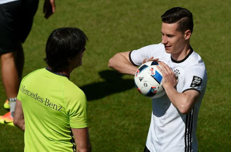 Germany's head coach Joachim Loew talks to Julian Draxler during a training session as part of the team's preparation for the upcoming Euro 2016 European football championships, on May 26, 2016 in Ascona