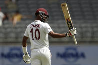 West Indies' Roston Chase raises his bat after making 50 runs against Australia on the 5th day of their cricket test in Perth, Australia, Sunday, Dec. 4, 2022. (AP Photo/Gary Day)