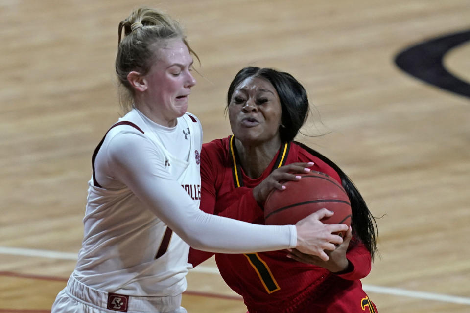 Boston College guard Cameron Swartz (1) and Louisville guard Dana Evans (1) compete for possession of the ball in the first half of an NCAA college basketball game, Thursday, Feb. 4, 2021, in Boston. (AP Photo/Elise Amendola)
