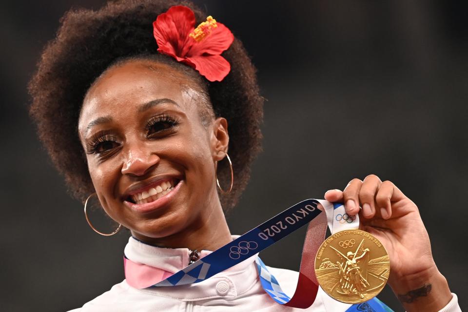 Gold medalist Puerto Rico's Jasmine Camacho-Quinn poses on the podium for the women's 100m hurdles final during the Tokyo 2020 Olympic Games at the Olympic Stadium in Tokyo on August 2, 2021 (AFP via Getty Images)