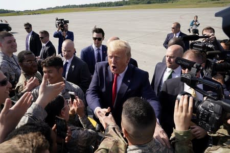 U.S. President Donald Trump meets servicemembers during a refueling stop at Joint Base Elmendorf, Alaska, U.S. on his way to the G-20 Summit in Osaka, Japan