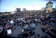 Marchers lay down on the Burnside Bridge for nine minutes on Tuesday evening, June 2, 2020, symbolizing the amount of time a Minneapolis police officer knelt on George Floyd's neck. Floyd died after being restrained by Minneapolis police officers on May 25. (Sean Meagher/The Oregonian via AP)