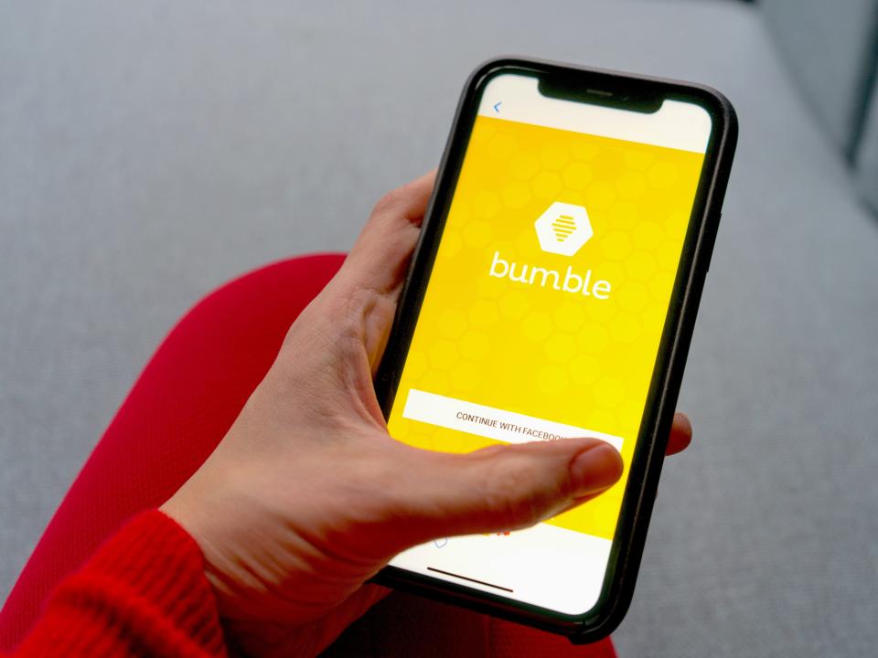 Hand holding phone with bumble open on screen