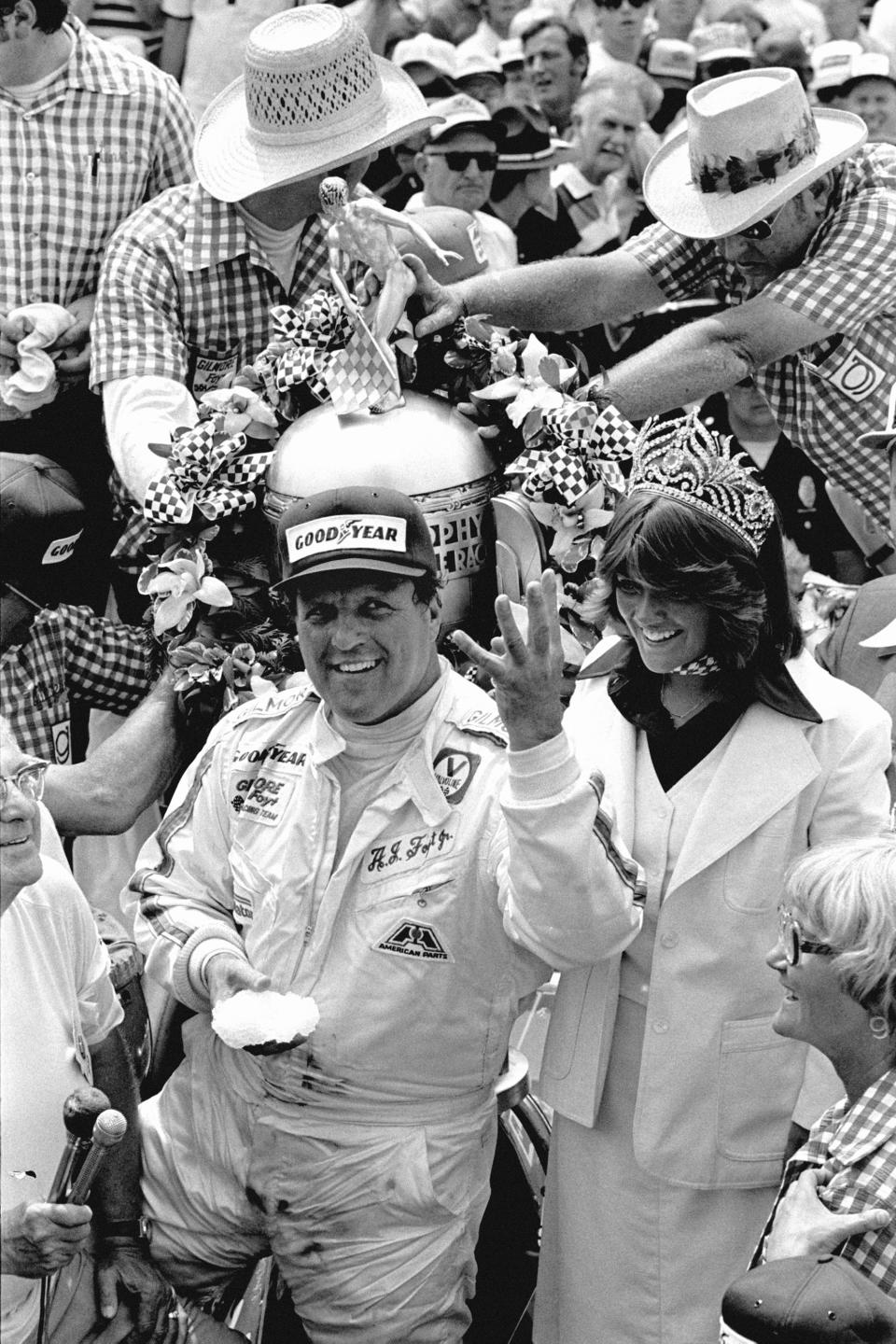 FILE - A.J. Foyt holds up four fingers in the winner's circle at Indianapolis Motor Speedway Sunday, May 29, 1977 as he became the first person to in the Indy 500 four times. (AP Photo/File)