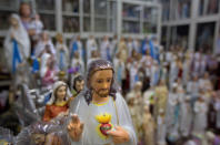 In this Saturday, Nov. 3, 2018, photo, Catholic statues are seen for sale in a shop next to a Church in Kottayam in the southern Indian state of Kerala. An AP investigation has uncovered a decades-long history of nuns in India enduring sexual abuse from within the Catholic church. (AP Photo/Manish Swarup)