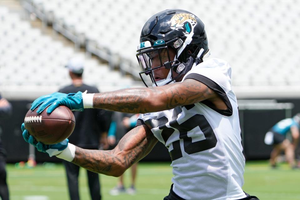 Jacksonville Jaguars safety Antonio Johnson catches a pass on a defensive drill during an NFL football rookie camp, Friday, May 12, 2023, in Jacksonville, Fla. (AP Photo/John Raoux)