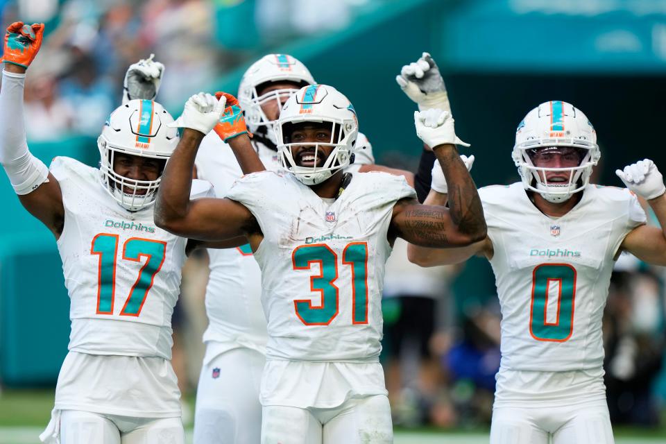 Miami Dolphins running back Raheem Mostert (31) celebrates with his teammates after scoring a touchdown during the second half of an NFL football game against the Carolina Panthers, Sunday, Oct. 15, 2023, in Miami Gardens, Fla. (AP Photo/Wilfredo Lee)