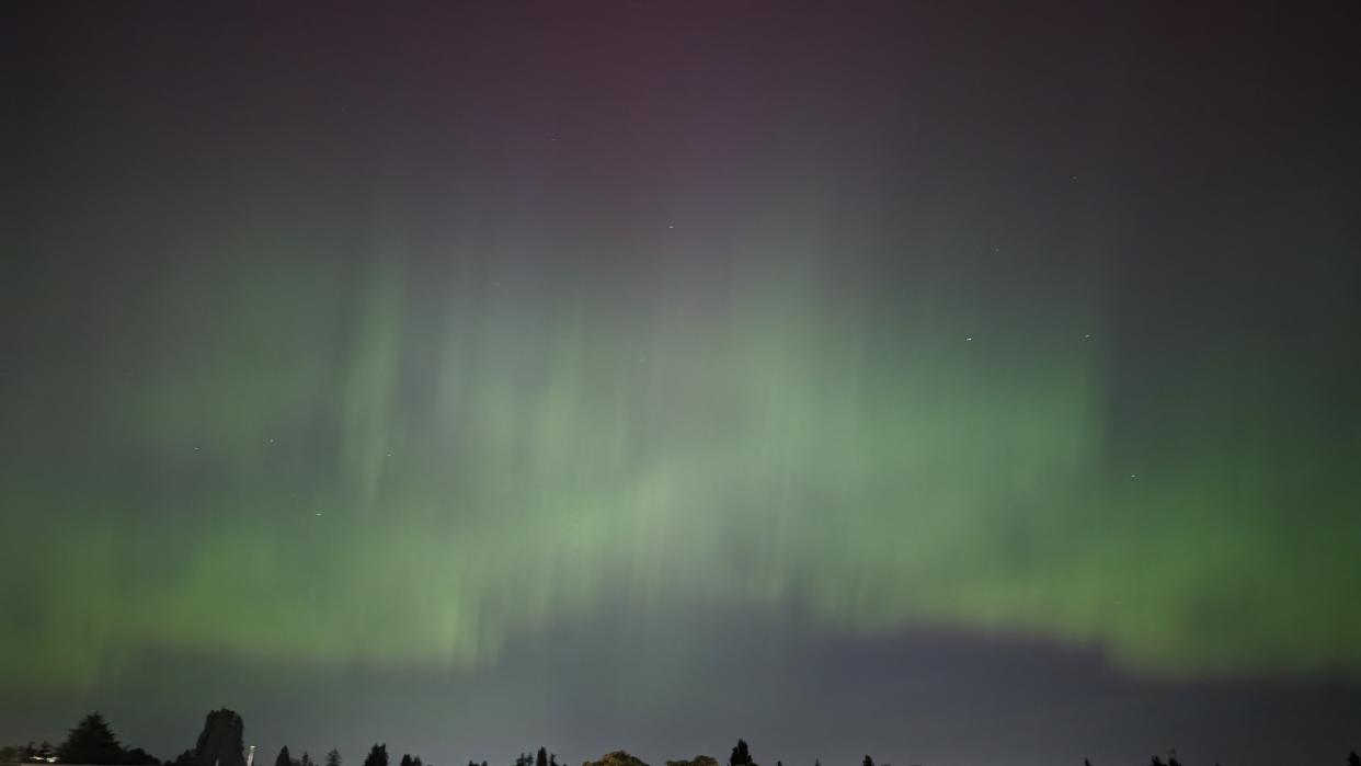  A photo of the northern lights in the night sky. 