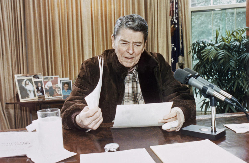 FILE - In this Jan. 14, 1989 photo provided by the White House, President Ronald Reagan gives his final radio speech to the nation, from the Oval Office in Washington. On Friday, Feb. 1, 2018, The Associated Press has found that stories circulating on the internet that Reagan never took his jacket off in the Oval Office in eight years, are untrue. (AP Photo/White House/Susan Biddle)