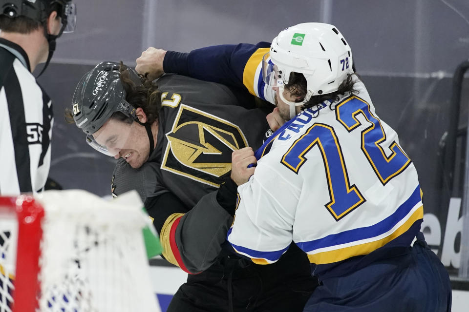 Vegas Golden Knights right wing Mark Stone, left, fights with St. Louis Blues defenseman Justin Faulk (72) during the second period of an NHL hockey game Tuesday, Jan. 26, 2021, in Las Vegas. (AP Photo/John Locher)