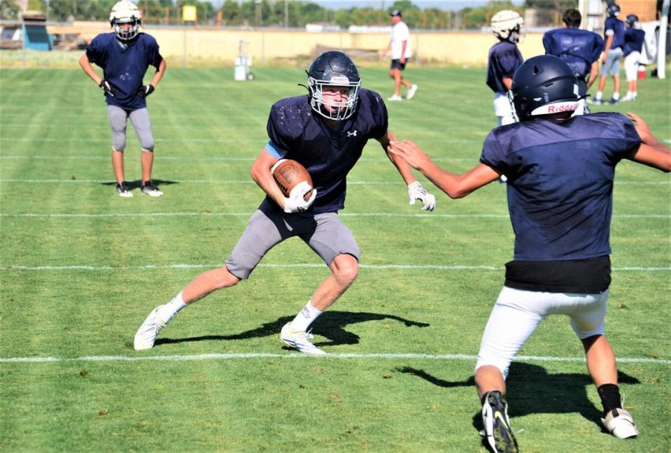 Stone Ridge Christian High School senior Aiden Skeen makes a catch and attempts to make a move against a defender during practice on Tuesday, Aug. 8, 2023.