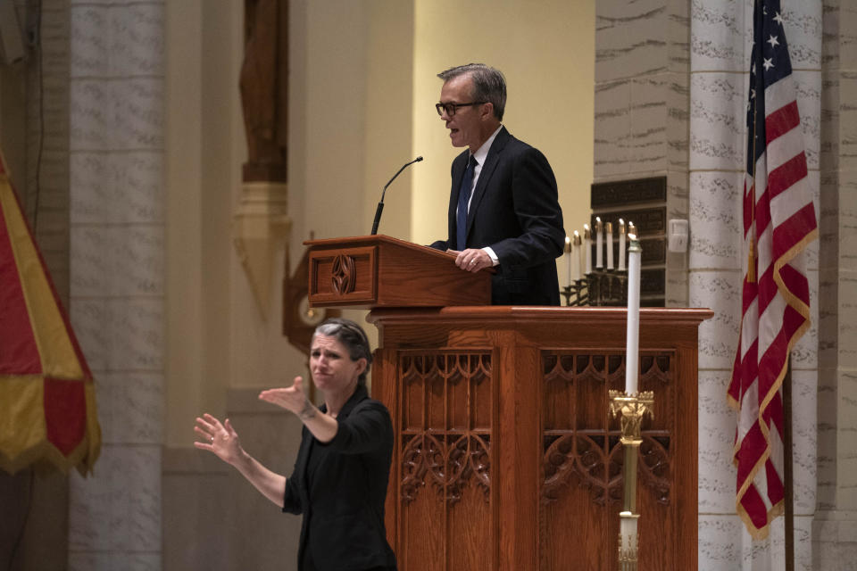 Sports commentator and Lewiston native Tom Caron hosts a vigil for the victims of Wednesday's mass shootings at the Basilica of Saints Peter and Paul, on Sunday, Oct. 29, 2023, in Lewiston, Maine. (AP Photo/Robert F. Bukaty)