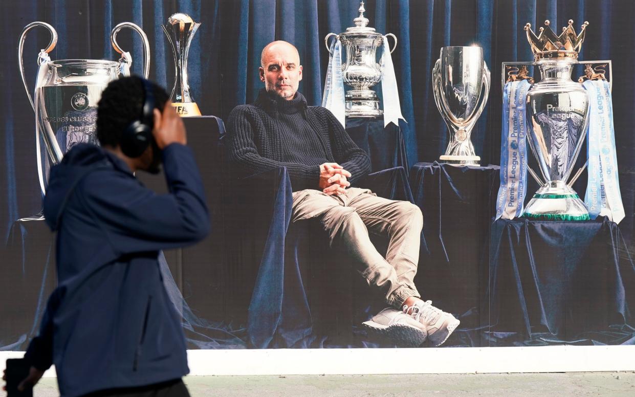 Pep Guardiola on a poster outside the Etihad