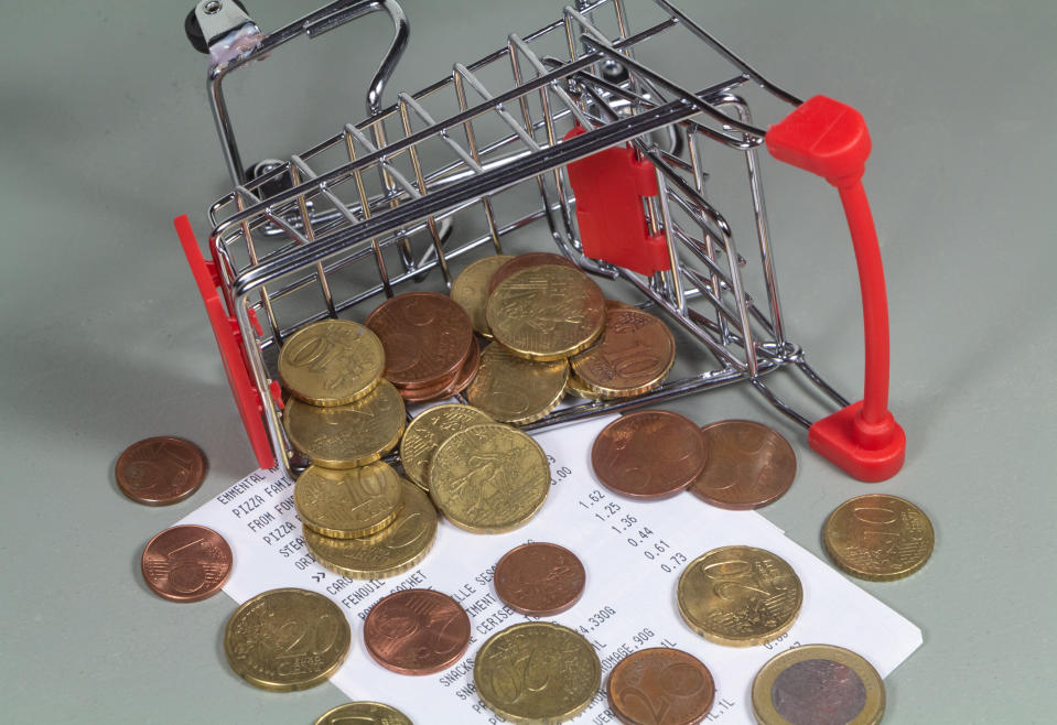 Small shopping cart blown over, till receipt and euros coins