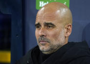 Manchester City's head coach Pep Guardiola watches ahead of the Champions League round of 16 second leg soccer match between Manchester City and RB Leipzig at the Etihad stadium in Manchester, England, Tuesday, March 14, 2023. (AP Photo/Dave Thompson)