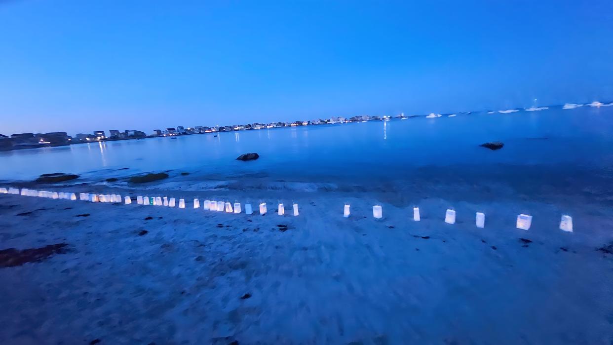 Scituate residents placed illuminated lanterns along the seashore in support of Scituate Public Schools Diversity, Equity and Inclusion Director jamele adams, who was the target of a hateful message in July.