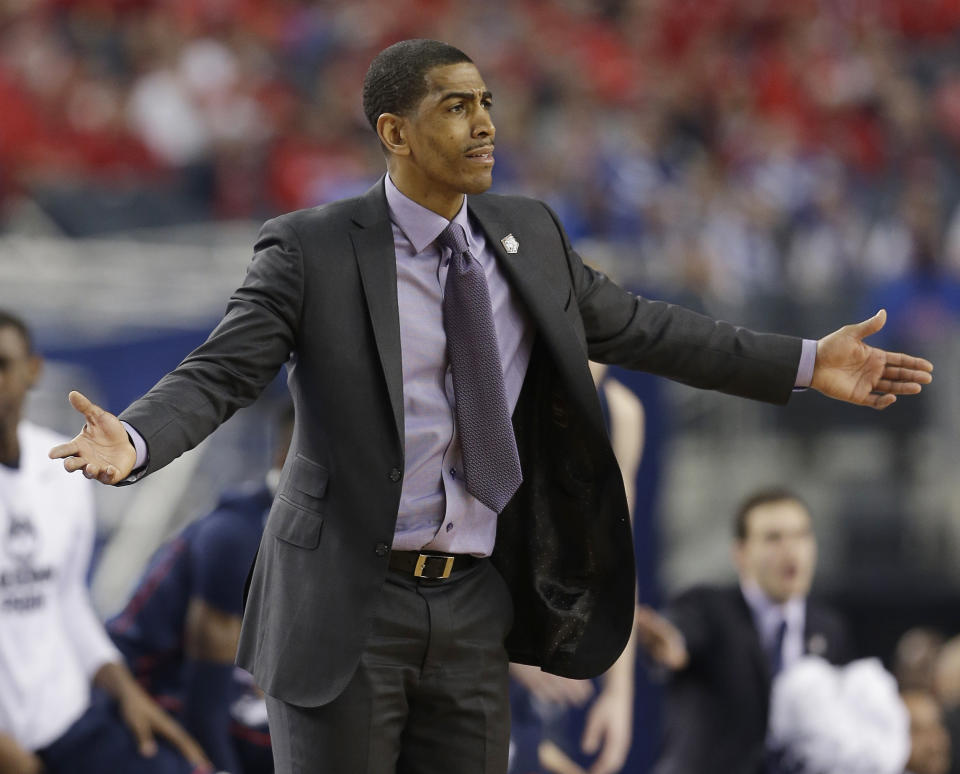 Connecticut head coach Kevin Ollie reacts during the first half of the NCAA Final Four tournament college basketball semifinal game against Florida Saturday, April 5, 2014, in Arlington, Texas. (AP Photo/David J. Phillip)