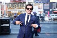 John Leguizamo flashes peace signs during a visit to <em>Extra</em> at The Levi’s Store in Times Square on Wednesday in N.Y.C. 
