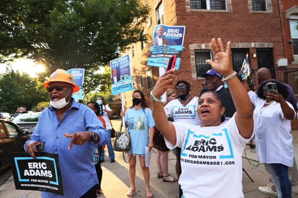 Supporters of New York City mayoral candidate Eric Adams celebrate after he exits his polling location after voting during Primary Election Day at P.S. 81 on June 22, 2021 in the Bedford-Stuyvesant neighborhood of Brooklyn borough in New York City. (Photo by Michael M. Santiago/Getty Images)