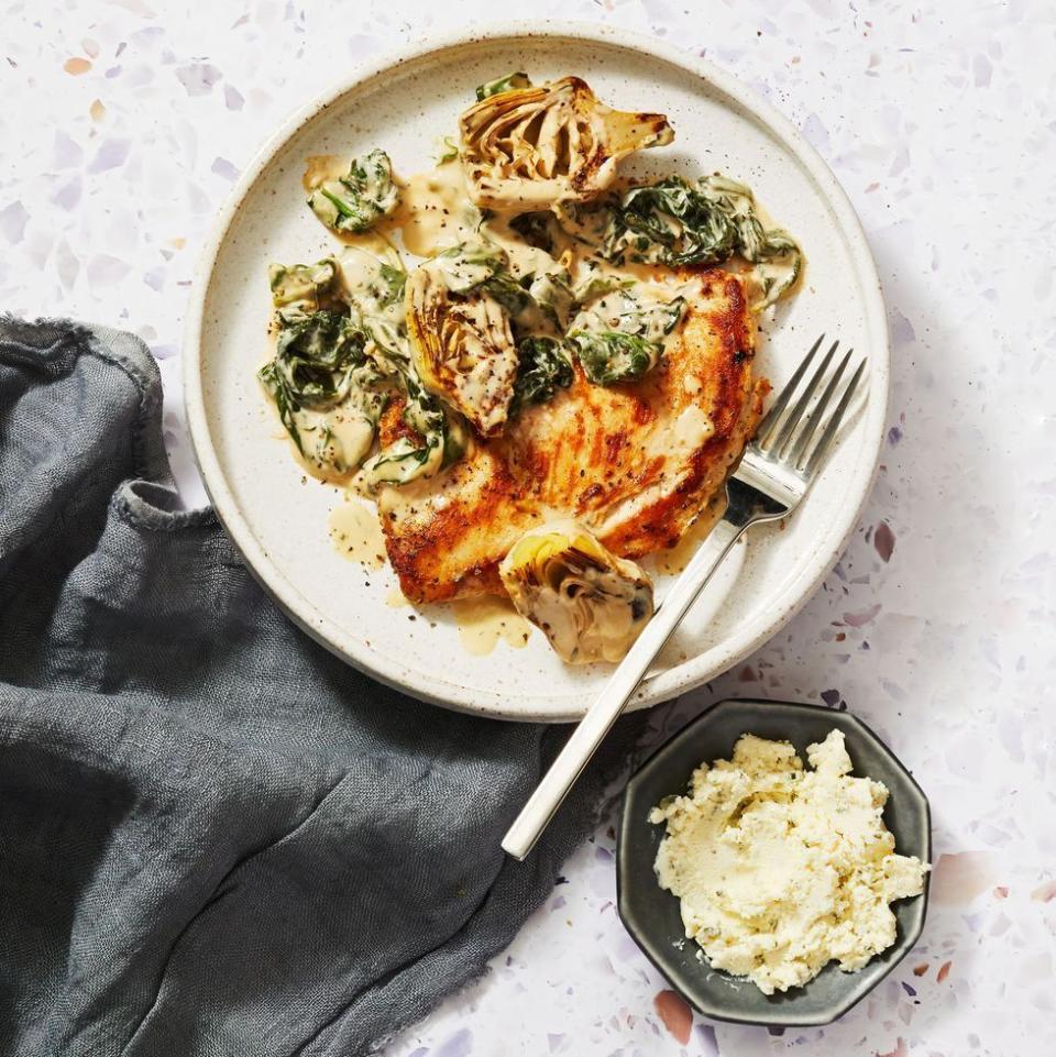 <p>Even with only 5 ingredients, this creamy chicken dish packs in the flavor!</p><p>Get the <strong><a href="https://www.goodhousekeeping.com/food-recipes/a39786064/spinach-artichoke-chicken-recipe/" rel="nofollow noopener" target="_blank" data-ylk="slk:Spinach Artichoke Chicken recipe;elm:context_link;itc:0;sec:content-canvas" class="link ">Spinach Artichoke Chicken recipe</a></strong>. </p>