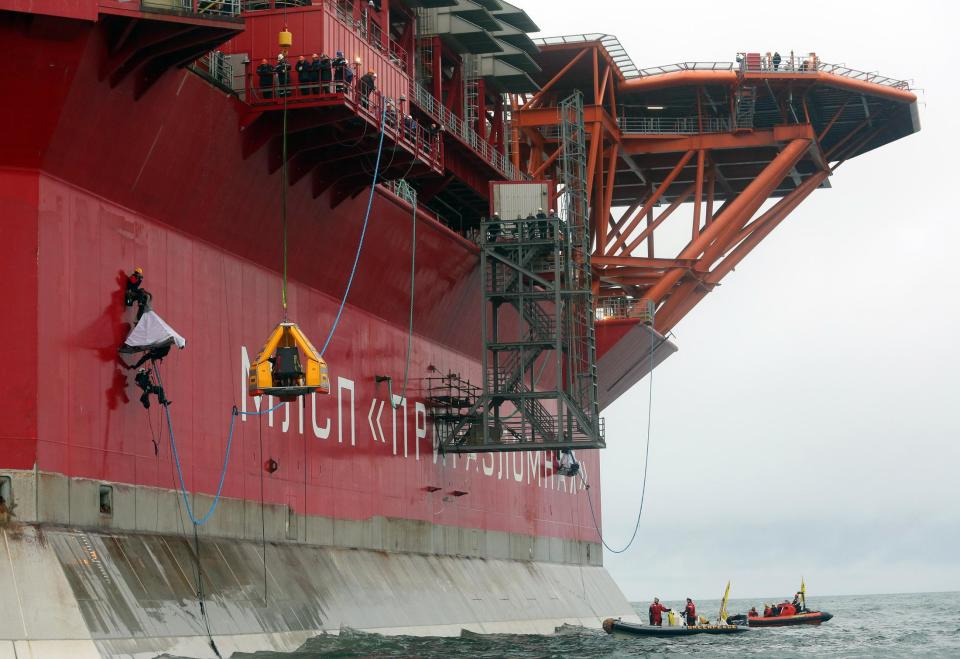 Greenpeace activists including Executive Director of Greenpeace International, Kumi Naidoo, board energy giant Gazprom's Arctic oil platform Prirazlomnaya off the North-eastern coast of Russia in the Pechora Sea on Friday, Aug. 24, 2012. Greenpeace activists have stormed a floating oil rig in Russia’s Pechora Sea to protest oil drilling in the Arctic, the environmental organization said on Friday. (AP Photo/ Denis Sinyakov, Greenpeace)