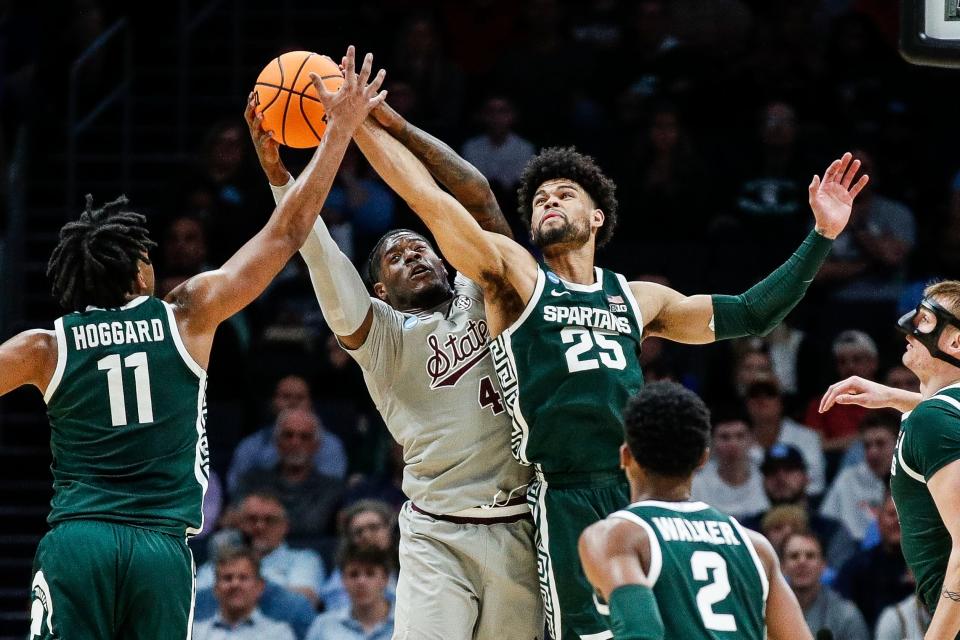 Michigan State forward Malik Hall (25), guard A.J. Hoggard (11) and Mississippi State forward Cameron Matthews (4) battle for a rebound during the first half of NCAA tournament West Region first round at Spectrum Center in Charlotte, N.C. on Thursday, March 21, 2024.
