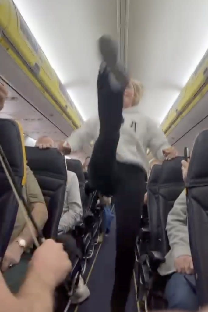 A passenger dances a jig in the aisle of a Ryanair flight Danny Walters / SWNS