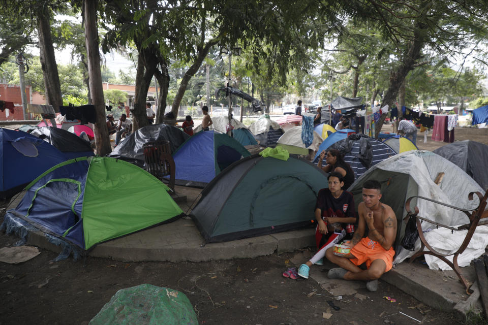 Migrants mostly from Venezuela and Cuba rest in a tent camp as they wait for a Honduras Migration transit permit to continue their way north to Guatemala, and hopefully make it to the Mexico-United States border, in Danlí, Honduras, Wednesday, Oct. 11, 2023. According to Honduras' immigration agency, at the country's southern border with Nicaragua, more than 18,300 migrants entered the town last week. (AP Photo/Elmer Martinez)