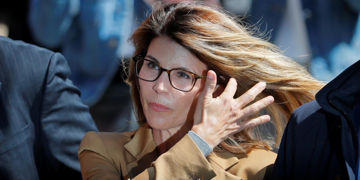 Actor Lori Loughlin, facing charges in a nationwide college admissions cheating scheme, is escorted to federal court in Boston, Massachusetts, in April 2019.