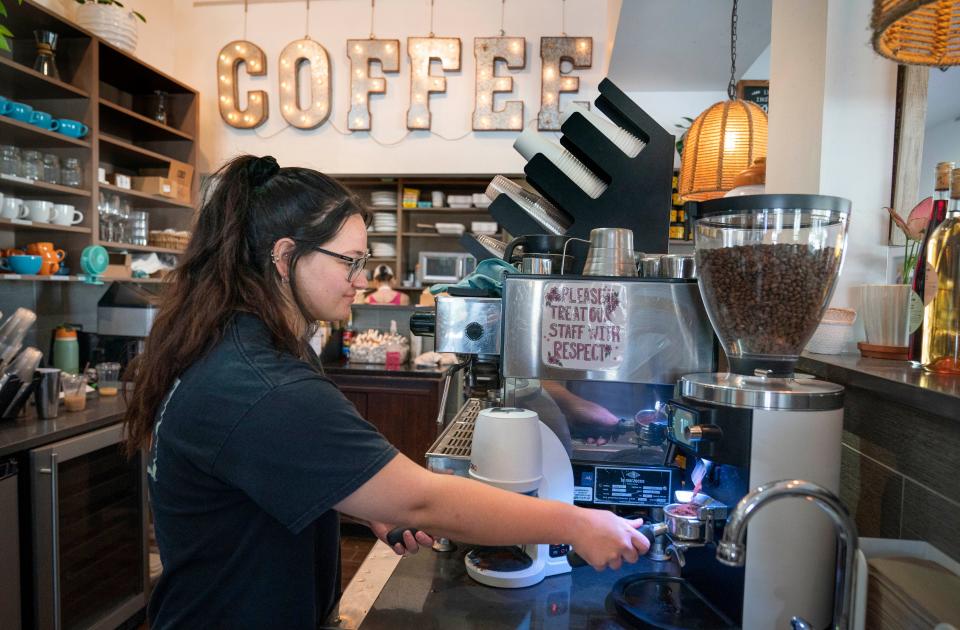 Makayla Coyle makes coffee for customers at the Perk Coffee House on April 18, 2024 in Tequesta, Florida.